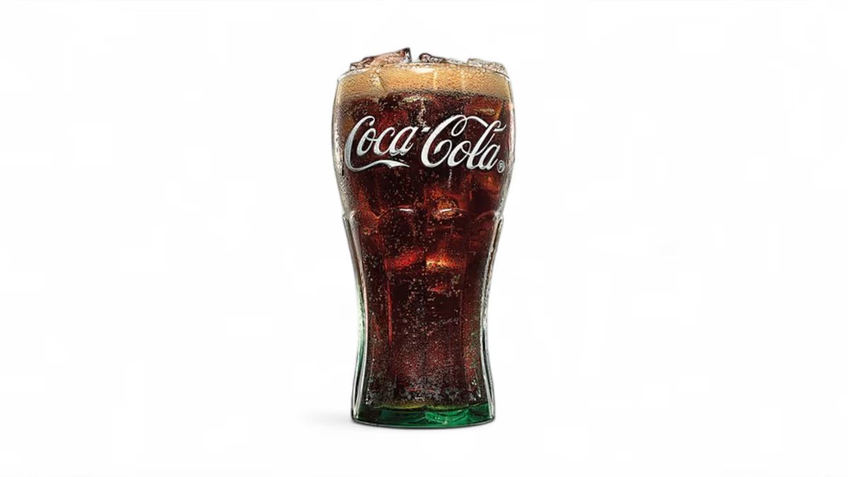 Coca-Cola in a branded glass with ice
