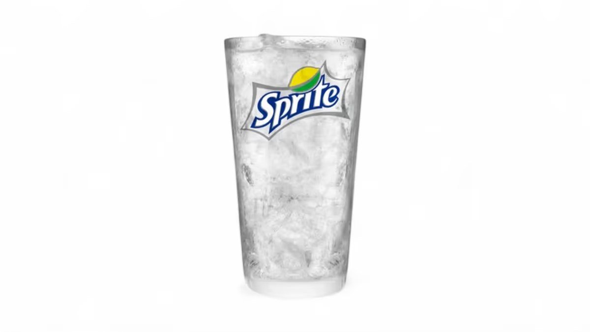 Sprite in a branded glass with ice